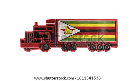 Toy truck with Zimbabwe flag shown isolated on white background. The concept of cargo transportation between countries.