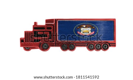 Toy truck with State of Utah flag shown isolated on white background. The concept of cargo transportation between countries.