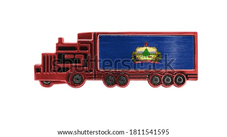Toy truck with State of Vermont flag shown isolated on white background. The concept of cargo transportation between countries.