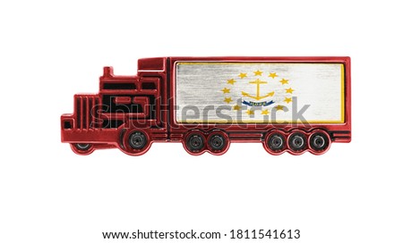 Toy truck with State of Rhode Island and Providence Plantations flag shown isolated on white background. The concept of cargo transportation between countries.