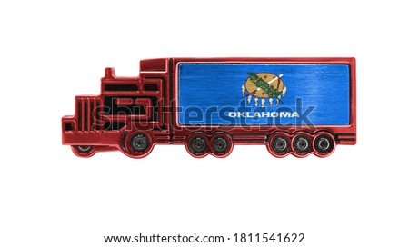 Toy truck with State of Oklahoma flag shown isolated on white background. The concept of cargo transportation between countries.