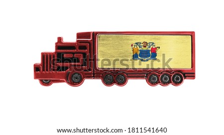Toy truck with State of New Jersey flag shown isolated on white background. The concept of cargo transportation between countries.