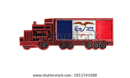 Toy truck with State of Iowa flag shown isolated on white background. The concept of cargo transportation between countries.