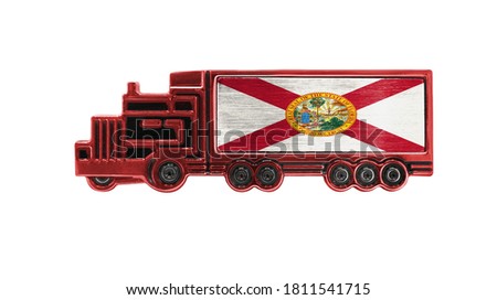 Toy truck with State of Florida flag shown isolated on white background. The concept of cargo transportation between countries.