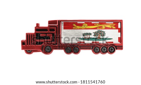 Toy truck with Prince Edward Island flag shown isolated on white background. The concept of cargo transportation between countries.