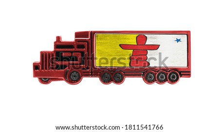 Toy truck with Nunavut flag shown isolated on white background. The concept of cargo transportation between countries.