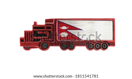 Toy truck with Nepal flag shown isolated on white background. The concept of cargo transportation between countries.