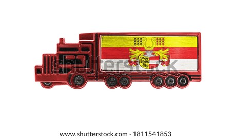 Toy truck with Carinthia flag shown isolated on white background. The concept of cargo transportation between countries.