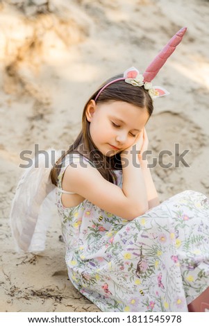 Girl 5 years old in a unicorn costume 