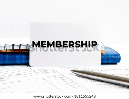 Business card with text Membership lying on blue notebook,concept