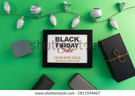 Black Friday Sale concept, gift box with photo frame on green background