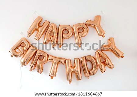 Happy Birthday! Rose gold sparkling balloons on white background. Celebration party anniversary decoration composition