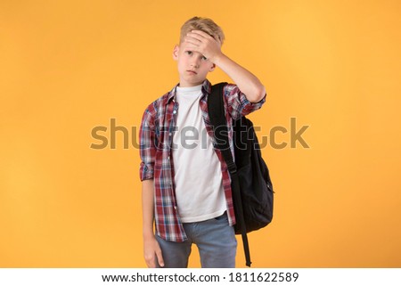 Sick Schoolboy Touching Forehead Having Fever And Headache Feeling Bad At School Posing On Pastel Orange Wall