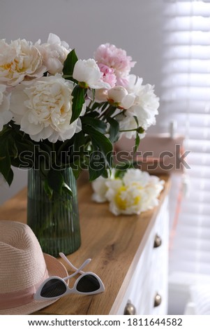 Bouquet of beautiful peony flowers in room