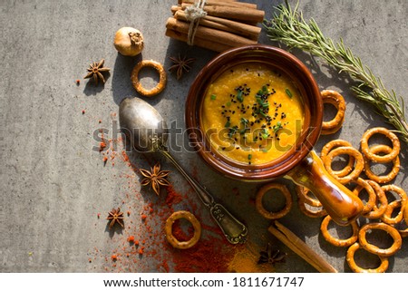 Roasted butternut squash soup with seasonal herbs. Healthy vegan dinner top view photo. Halloween dinner ideas. 