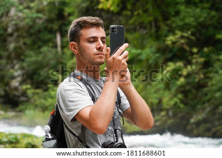 A guy taking a picture from his smartphone