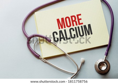 On a purple background a stethoscope with yellow list with text MORE CALCIUM