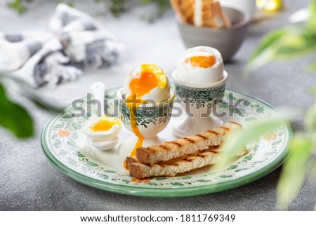 Soft-boiled egg in an eggcup with toast breakfast Royalty-Free Stock Photo #1811769349