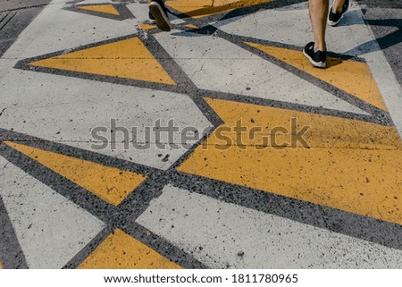 funky yellow and white pedestrian crossing