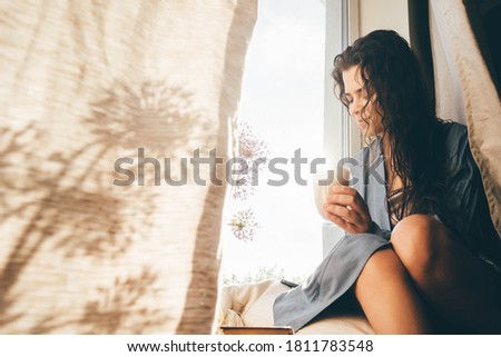 Woman drinking coffee at the sunny morning. 