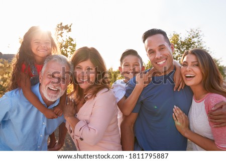 Portrait Of Multi-Generation Hispanic Family Relaxing In Garden At Home Together Royalty-Free Stock Photo #1811795887