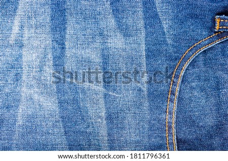 clothing items blue stonewashed faded jeans cotton fabric texture with seams, clasps, buttons and rivets, macro, close-up