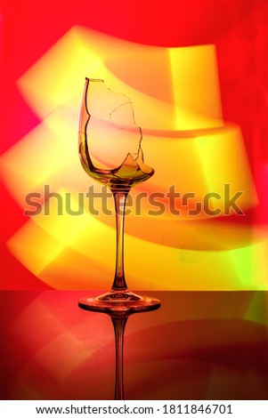 Art photo of a glass with multi-colored lighting