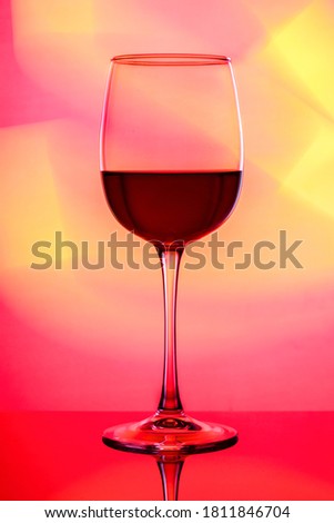 Art photo of a glass with multi-colored lighting