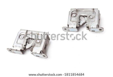 A pair of metal locks separately on a white isolated background in a photography studio, aluminum hood parts for replacement during repair or auto-parsing sale.