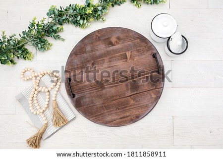 Blank rustic round wood serving tray on white background, famrmhouse style kitchen decor mockup