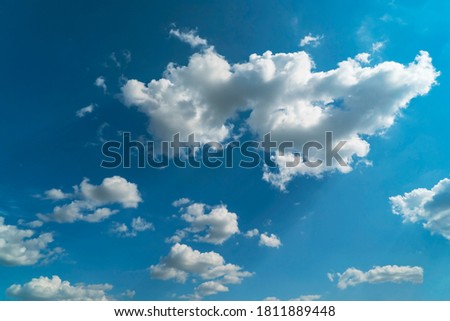 Picturesque multicolored clouds illuminated by sunlight. Dramatic blue sky background.
