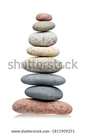 Balancing pyramid of stones isolated on white background.