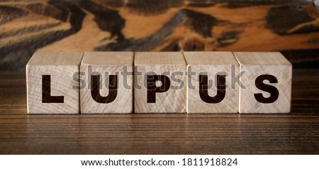 text lupus written on a blue background near tablets and a thermometer. medicines. High quality photo