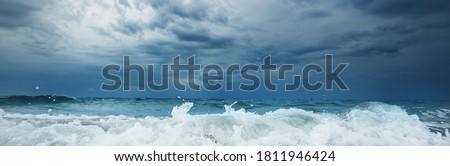 Picturesque panoramic view of a beach in Vlissingen, Netherlands. Storm sea, waves and water splashes close-up. Natural texture. Epic seascape. Travel destinations, sailing, cruise, vacations, nature Royalty-Free Stock Photo #1811946424