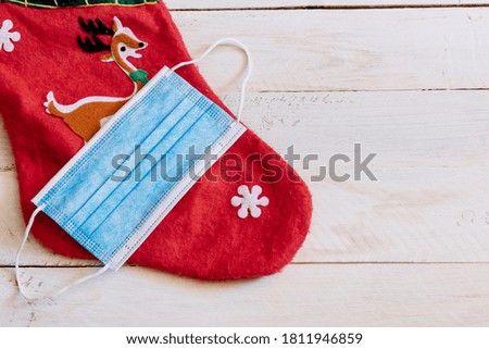 blue hygienic mask on christmas sock, christmas concept with covid19