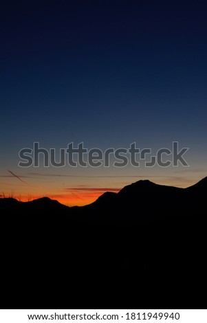 scenic sunset in Trentino Italy with mountains silhuette and colorful sky