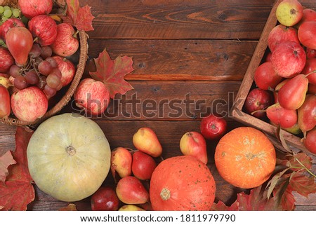 Happy Thanksgiving concept, postcard Autumn background with seasonal pears, pumpkins, apples and flowers on wooden background, copy space, selective focus. Harvesting