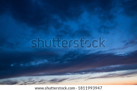 Dark clouds against a deep blue sky after sunset