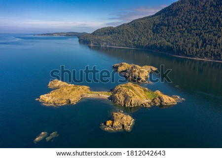 Lummi Rocks, In the Salish Sea, Washington State. Aerial view of one of the largest of the Bureau of Land Managements islands is Lummi Rocks, just off the west side of Lummi Island. Royalty-Free Stock Photo #1812042643