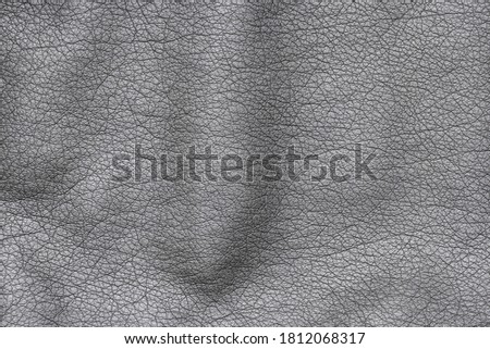 Close up of black stylish and fashion PU leather jacket texture with an interesting textured surface, isolated, background. Dark vintage biker jacket from leatherette cotton fabric material from above Royalty-Free Stock Photo #1812068317