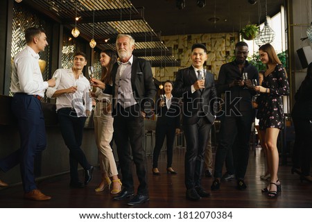 corporate businesspeople having fun and talking together in corporate party in club to celebrate spacial event such as corporate aniversary Royalty-Free Stock Photo #1812070384