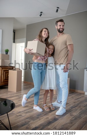 New residence. Young cute family moving to the new house and looking excited