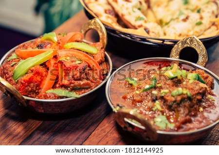 Indian food Curry butter chicken, Palak Paneer, Chiken Tikka, Biryani, Vegetable Curry, Papad, Dal, Palak Sabji, Jira Alu, Rice with Saffron on dark background Royalty-Free Stock Photo #1812144925