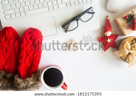 White Christmas, desk office with laptop, decoration and work supplies with cup of coffee. Top view with copy space for input the text. Flat lay desk table winter Christmas. Business Holidays Concept.