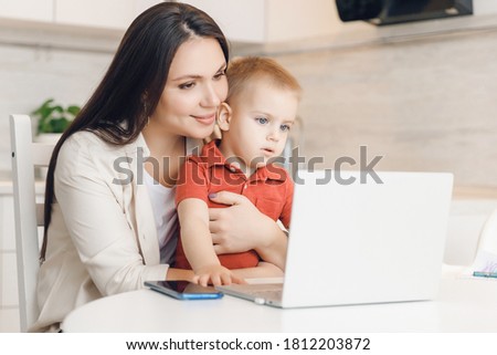 Woman and baby son having web video call with happy family on computer home. Communication people concept.