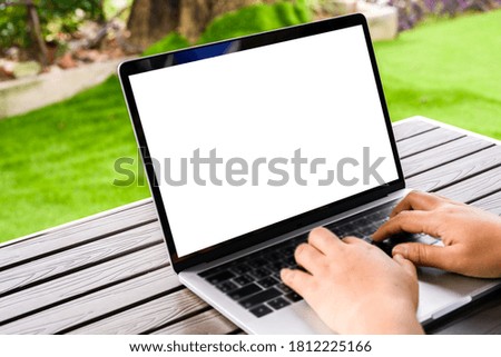 Businesswoman hand using laptop mockup white background on desk at coffee cafe. computer with blank screen.