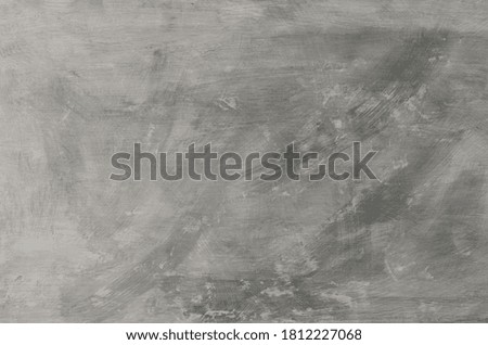 Textured concrete background with scratches and black and white spots.