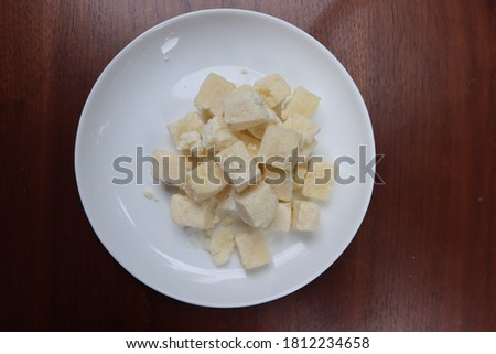 Frozen paneer or cottage cheese on white background, dairy product, processed food