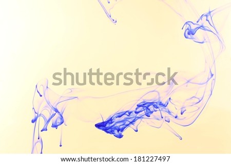 Ink in water on beige background