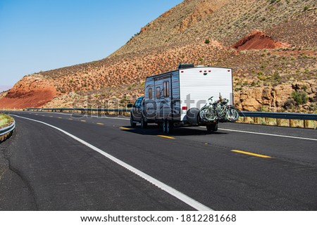 Mohave desert by Route 66. RV Camping, Camper Van on road. Caravan or recreational vehicle motor home trailer on a mountain road in America Royalty-Free Stock Photo #1812281668